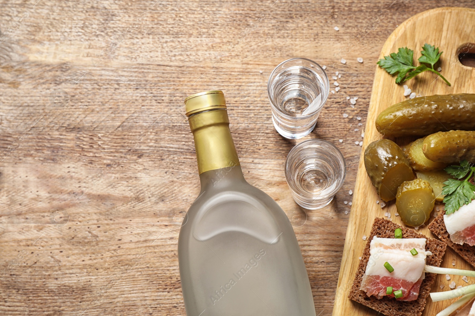 Photo of Flat lay composition with cold Russian vodka on wooden table, space for text