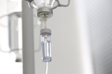 Photo of IV drip against blurred background, space for text