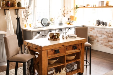 Stylish kitchen interior with wooden table and chairs