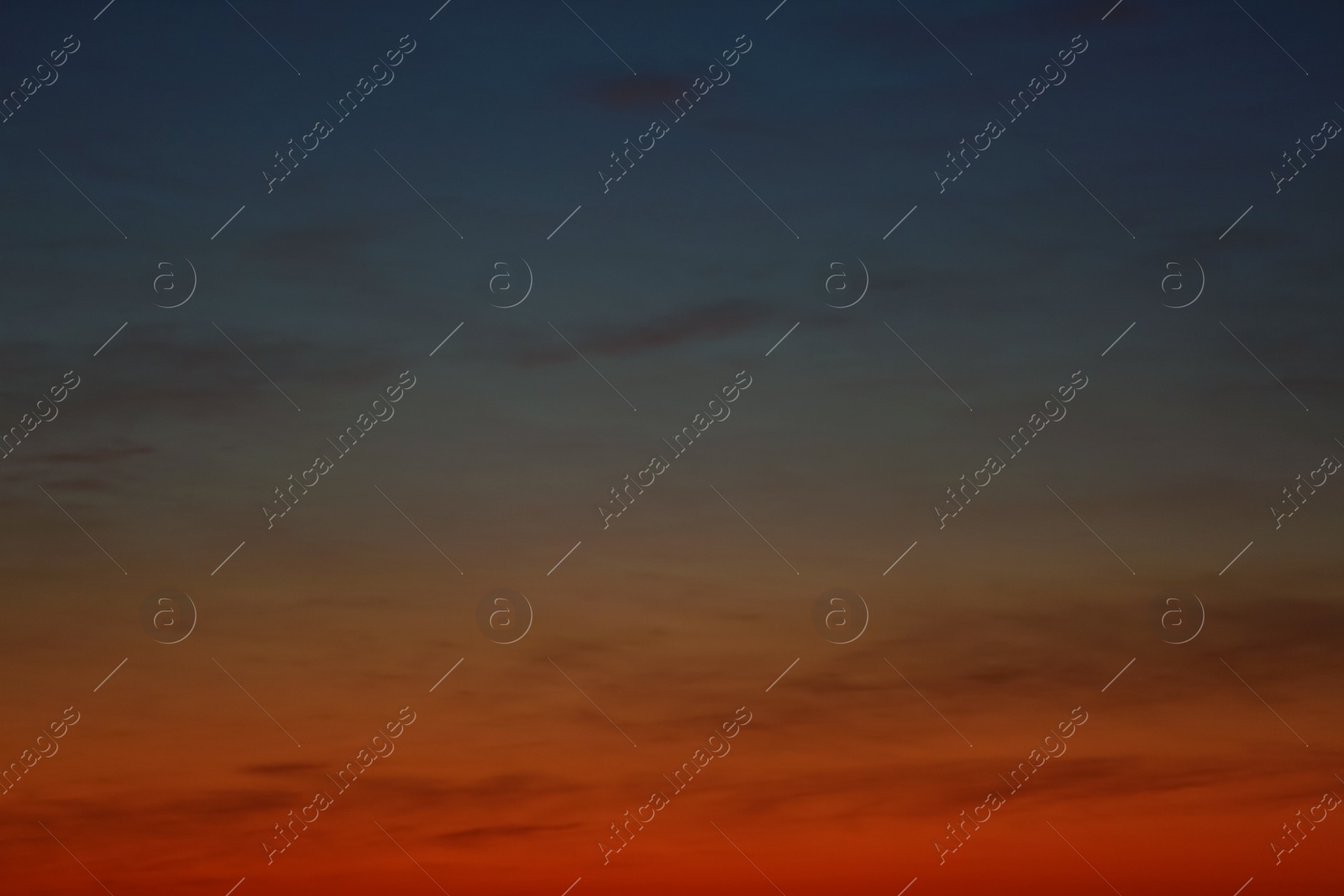 Photo of Picturesque view of beautiful sky lit by setting sun