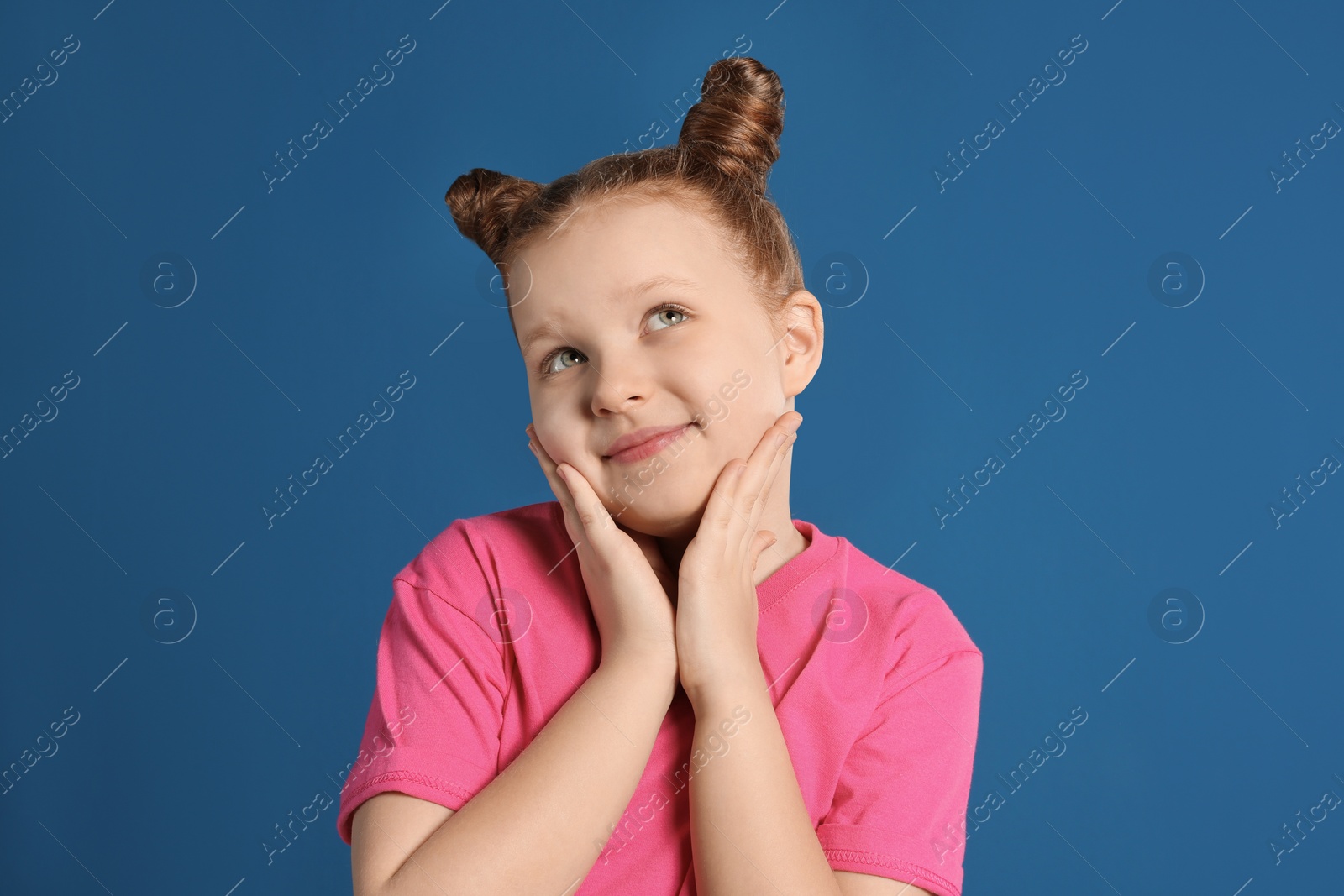 Photo of Portrait of little girl on blue background