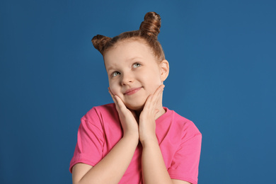 Photo of Portrait of little girl on blue background