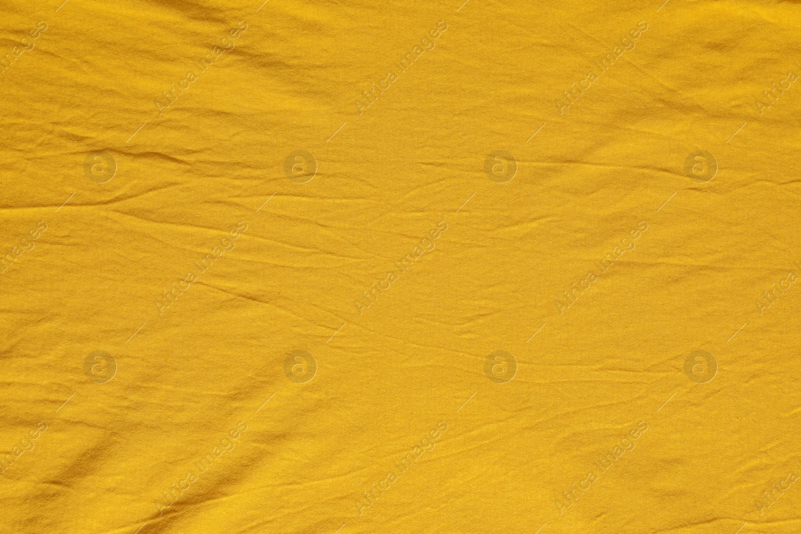 Photo of Crumpled orange fabric as background, top view