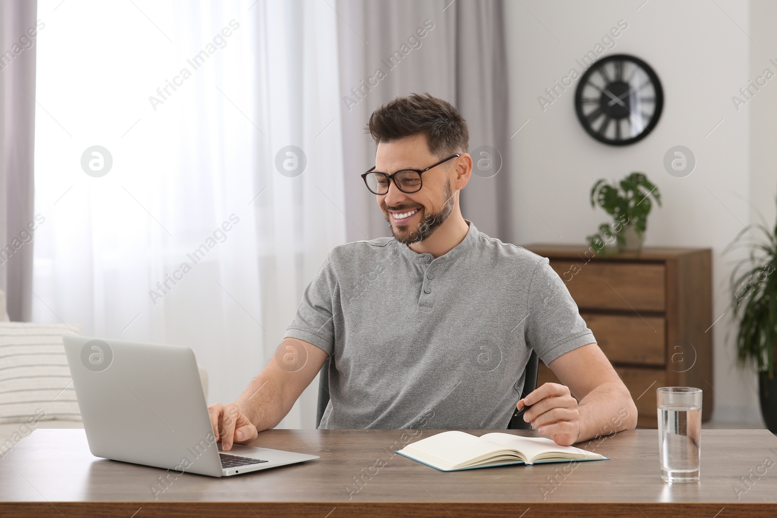 Photo of Man studying on laptop at home. Online translation course