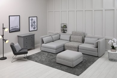 Section with storage near modular sofa in living room. Interior design