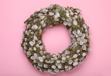 Photo of Wreath made of beautiful willow flowers on pink background, top view