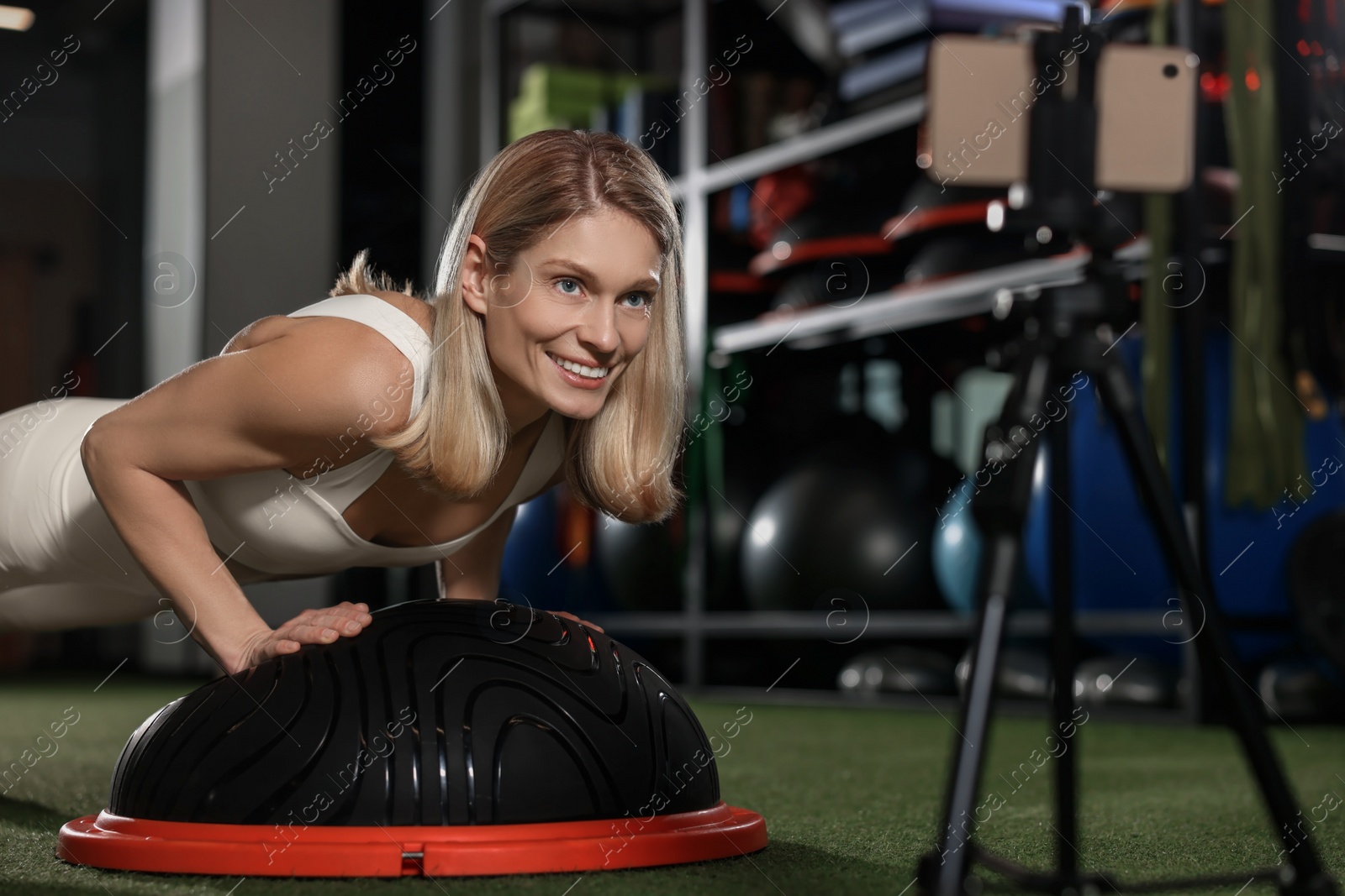 Photo of Fitness trainer recording online classes in gym