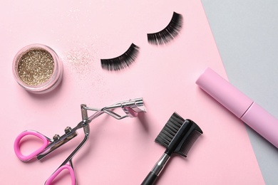 Photo of Flat lay composition with false eyelashes and other makeup products on color background