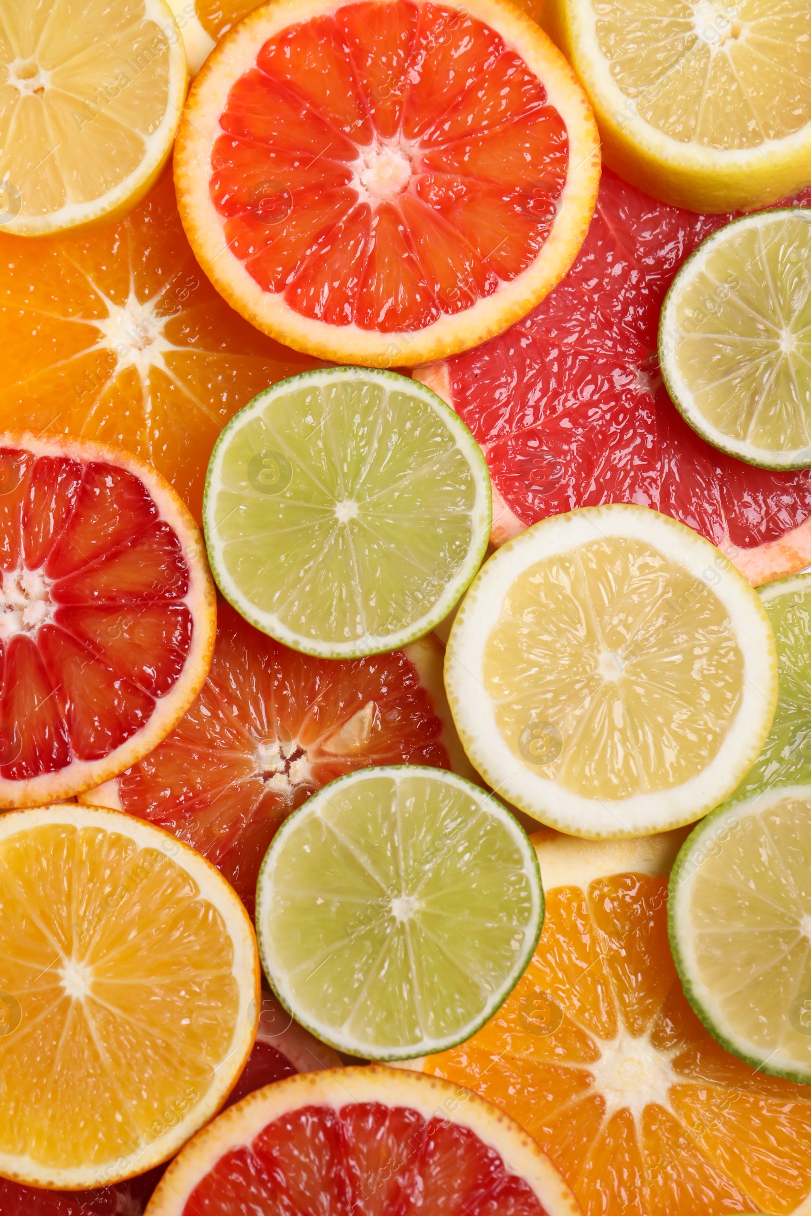 Photo of Fresh juicy citrus fruits as background, top view