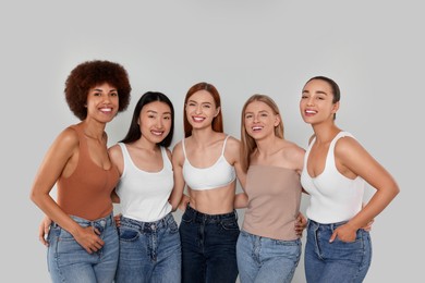 Photo of Group of beautiful young women on light grey background