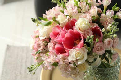 Photo of Beautiful bouquet of fresh flowers on table in room, closeup