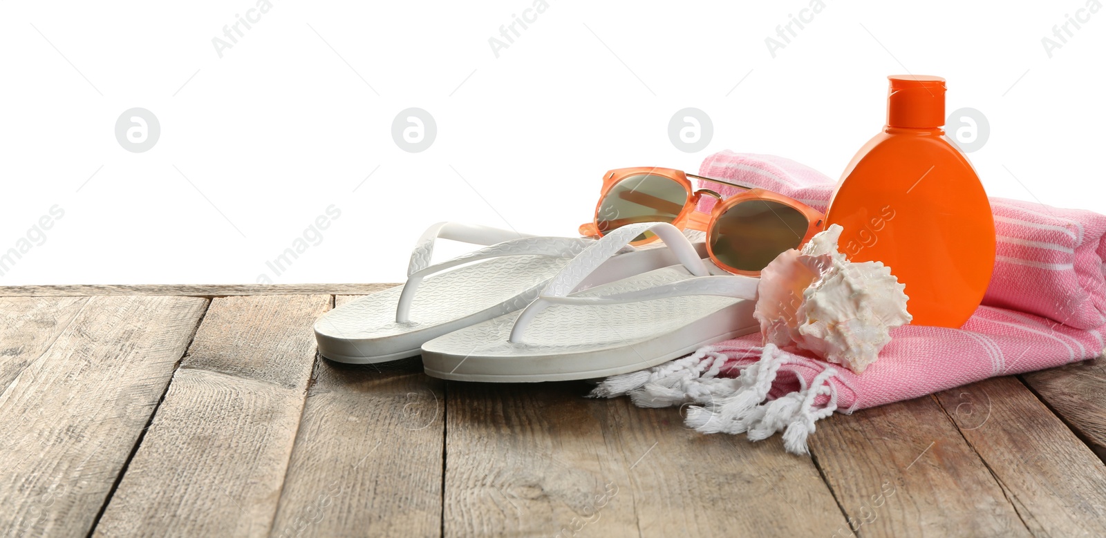 Photo of Beach accessories and sea shell on wooden table