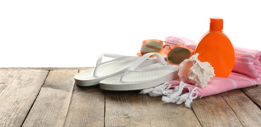 Beach accessories and sea shell on wooden table