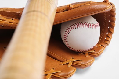 Baseball glove, bat and ball on white background, closeup