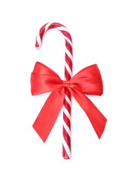 Photo of Sweet Christmas candy cane with red bow on white background, top view