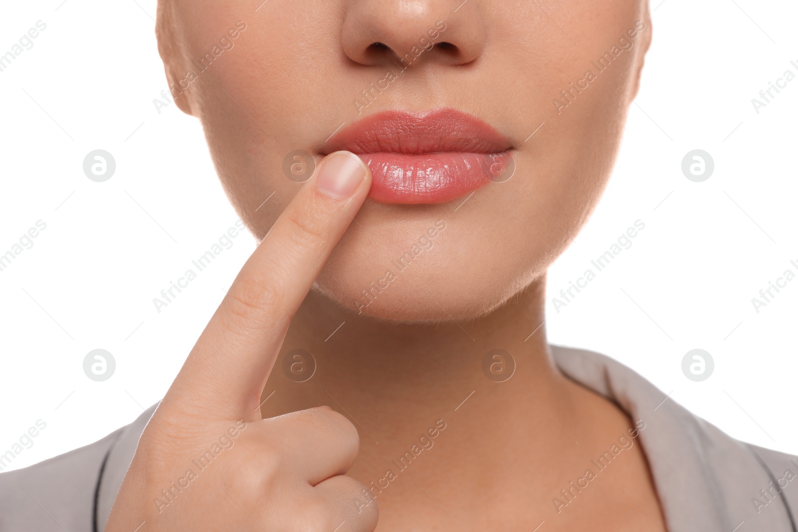 Photo of Woman with herpes touching lips on white background, closeup