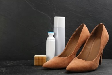 Stylish footwear with shoe care accessories on black table