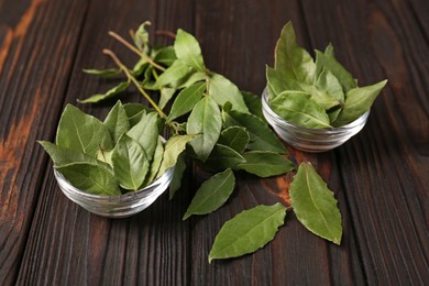 Aromatic fresh bay leaves on wooden table
