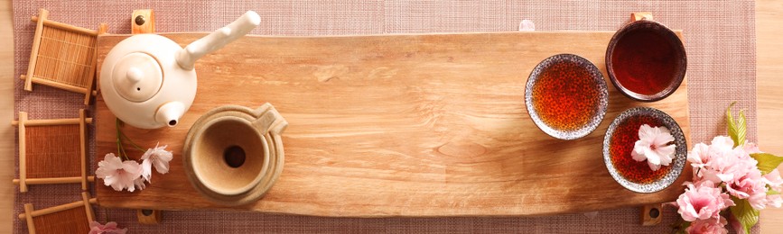Beautiful set for traditional tea ceremony on wooden table, flat lay. Banner design