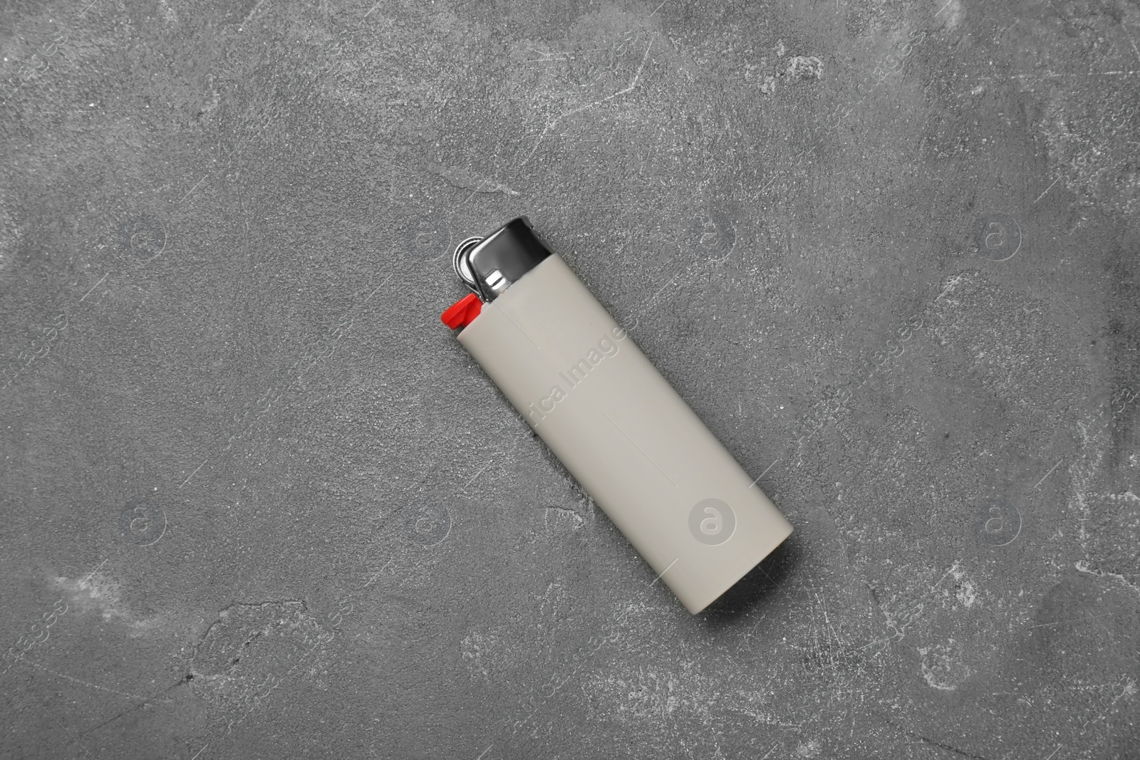 Photo of Stylish small pocket lighter on grey table, top view