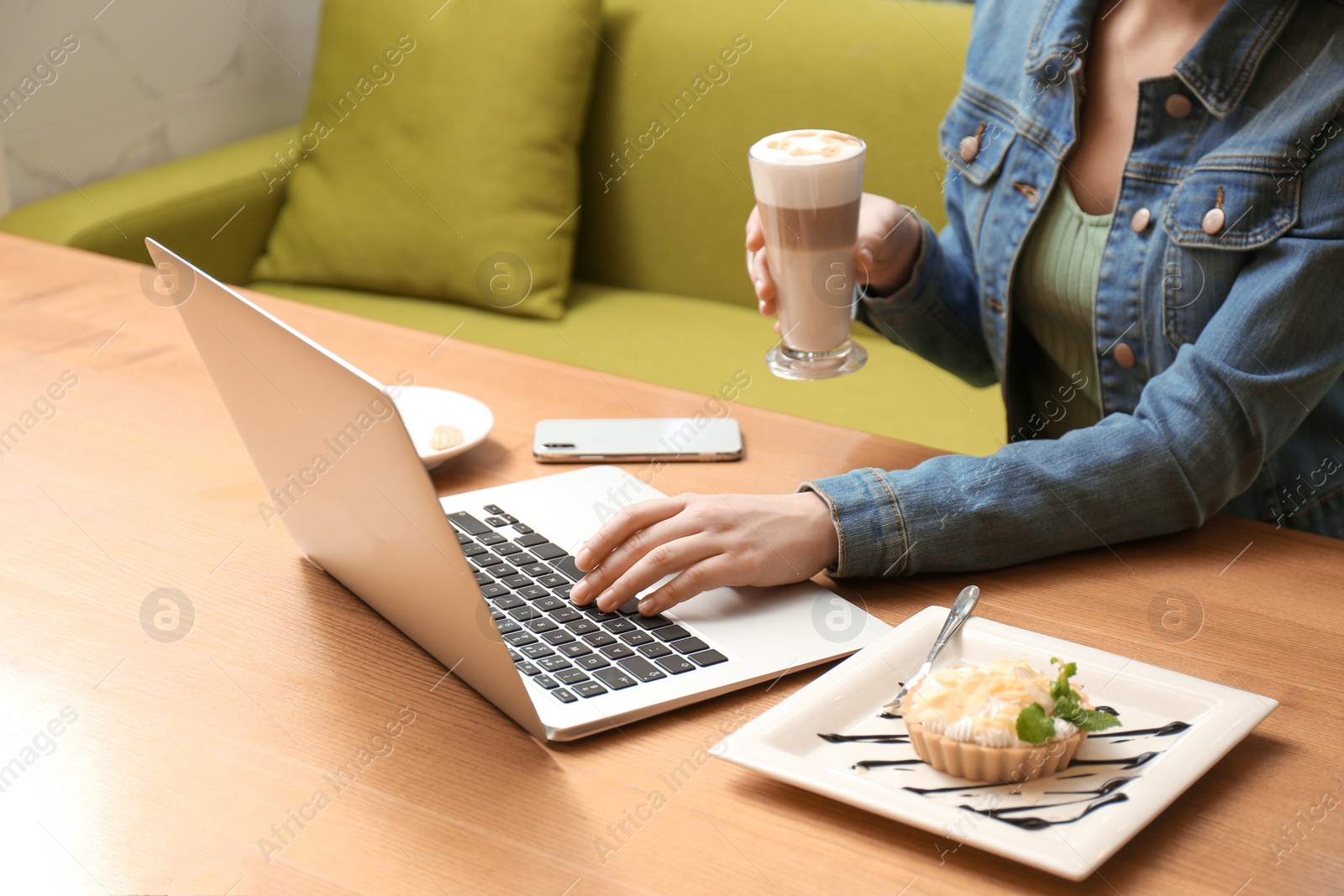 Photo of Blogger working with laptop in cafe, closeup