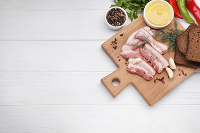 Slices of tasty pork fatback with dill and rye bread served on white wooden table, flat lay. Space for text