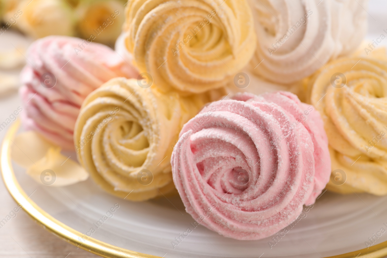 Photo of Yellow and pink delicious marshmallows on plate, closeup