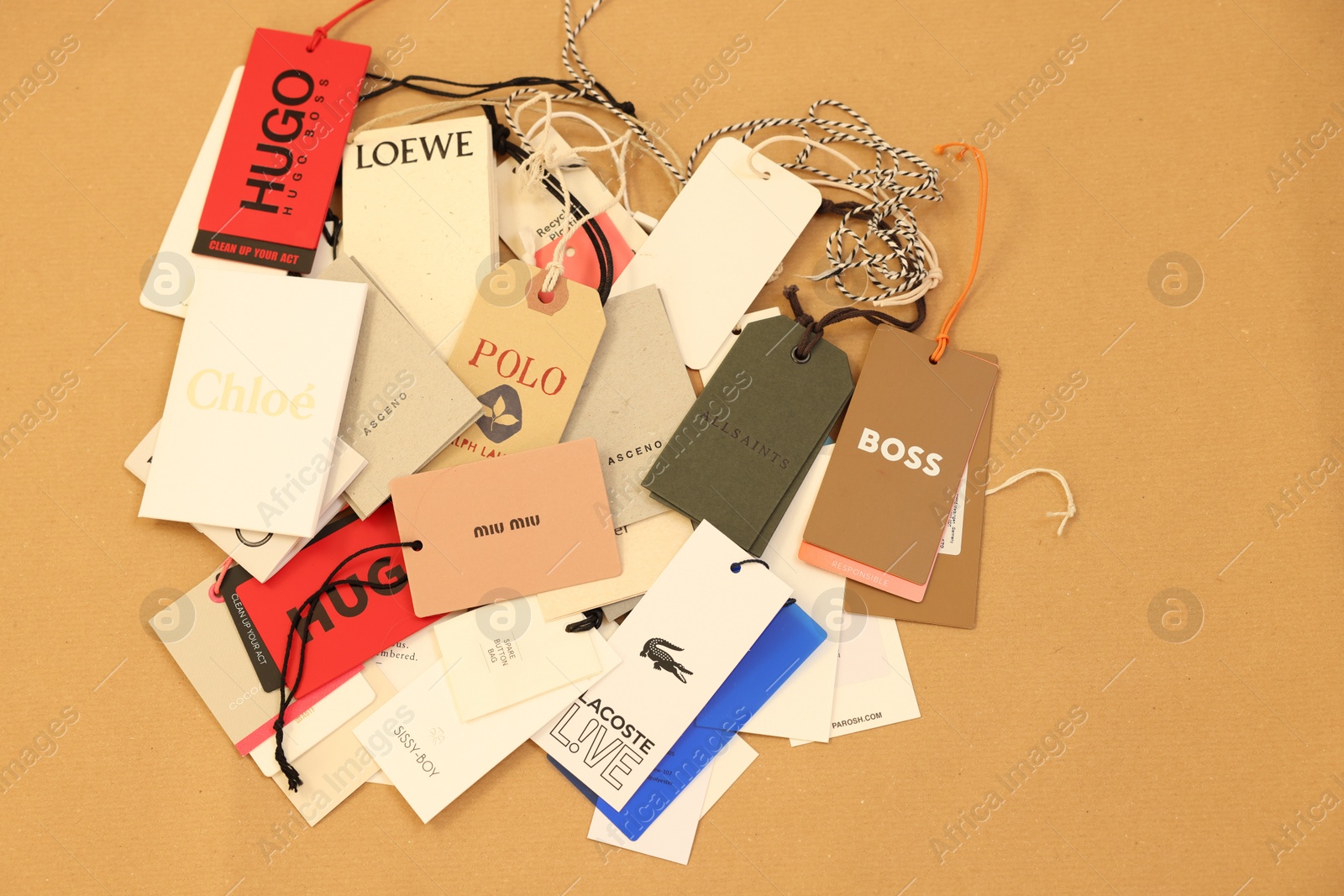 Photo of Leiden, Netherlands - December 6, 2023: Different clothing tags on kraft paper sheet, top view