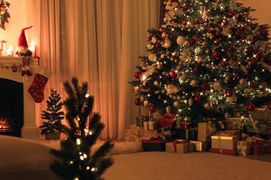 Photo of Festive living room interior with Christmas trees near fireplace