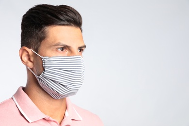 Photo of Man in protective face mask on white background