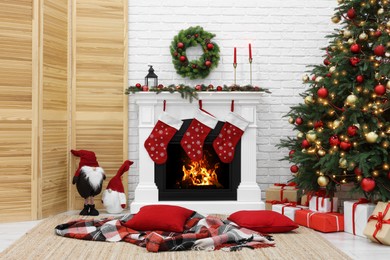 Photo of Cosy room with tree and fireplace decorated for Christmas. Interior design