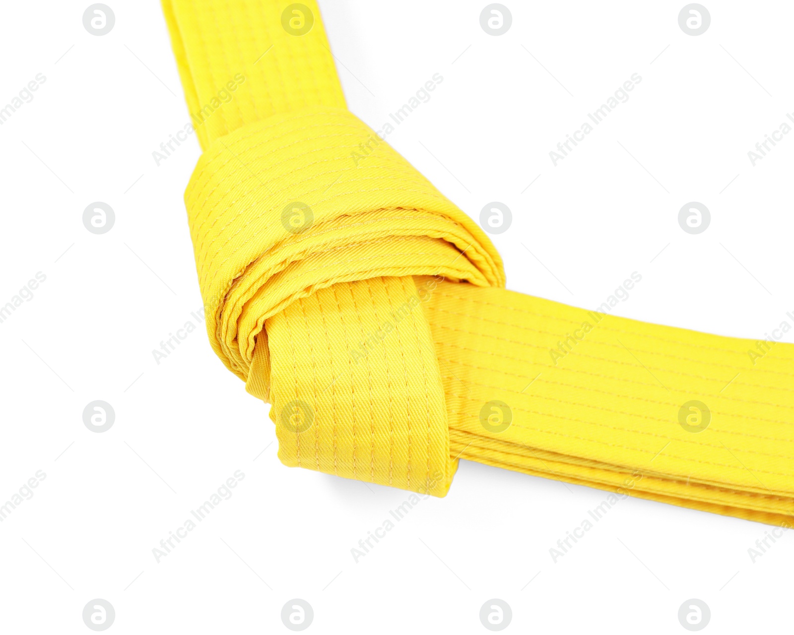 Photo of Yellow karate belt isolated on white. Martial arts uniform