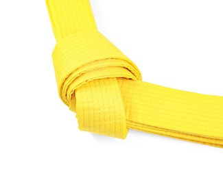 Photo of Yellow karate belt isolated on white. Martial arts uniform