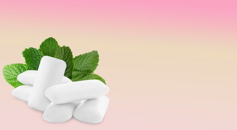 Menthol chewing gum pillows and mint leaves on pink gradient background, space for text