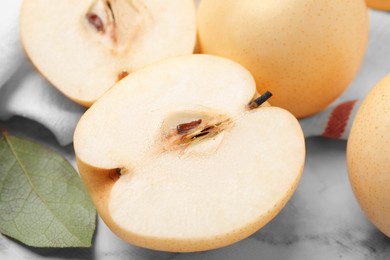 Photo of Delicious apple pears on white marble table, closeup