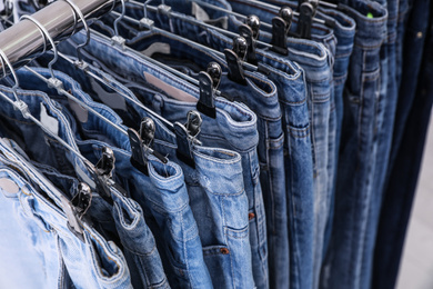 Photo of Closeup view of rack with different jeans