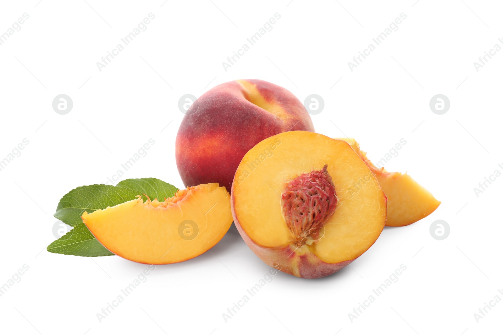 Photo of Whole and cut ripe peaches with leaves isolated on white