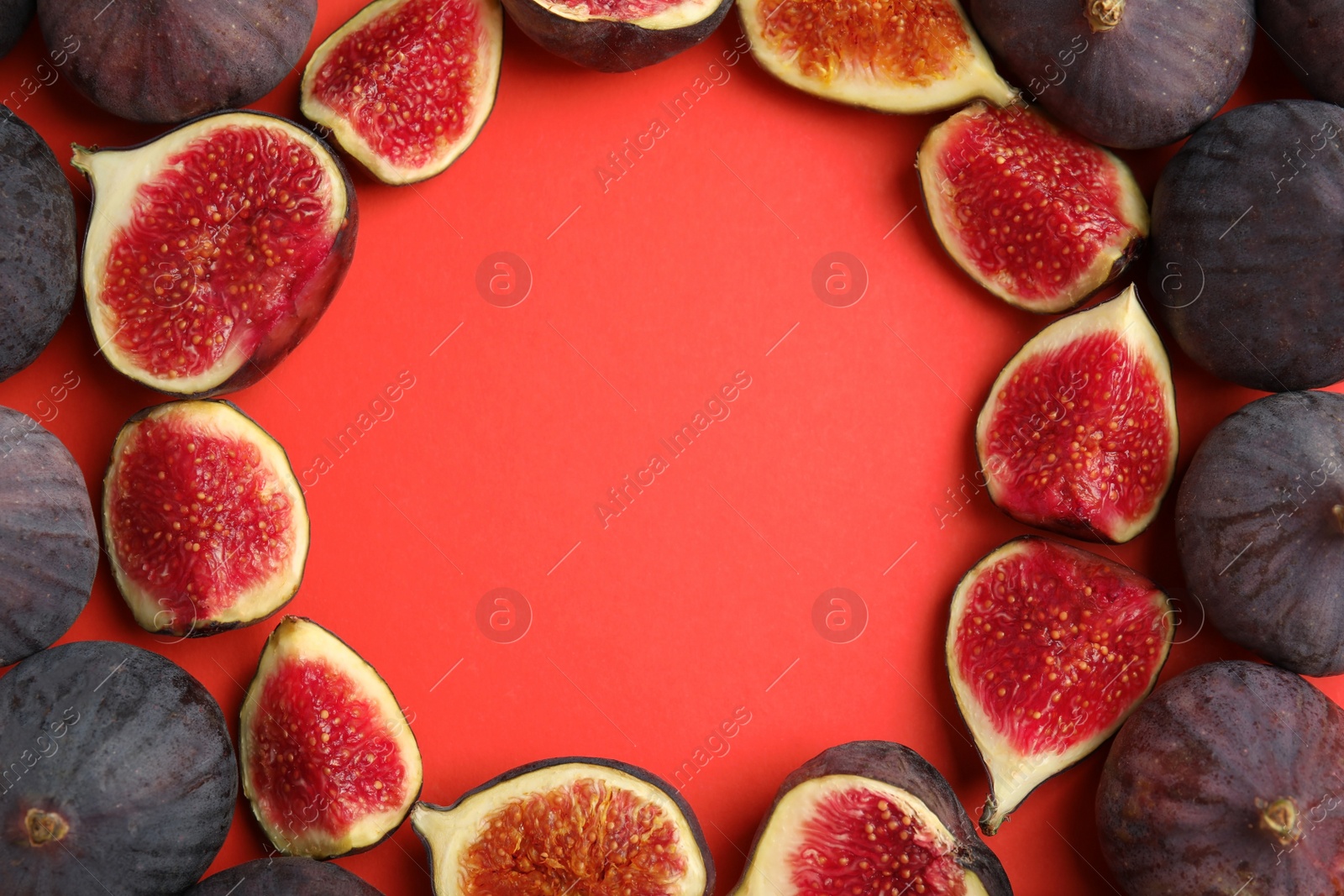 Photo of Frame made with delicious figs on red background, top view. Space for text