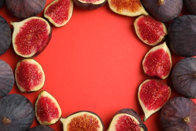 Frame made with delicious figs on red background, top view. Space for text