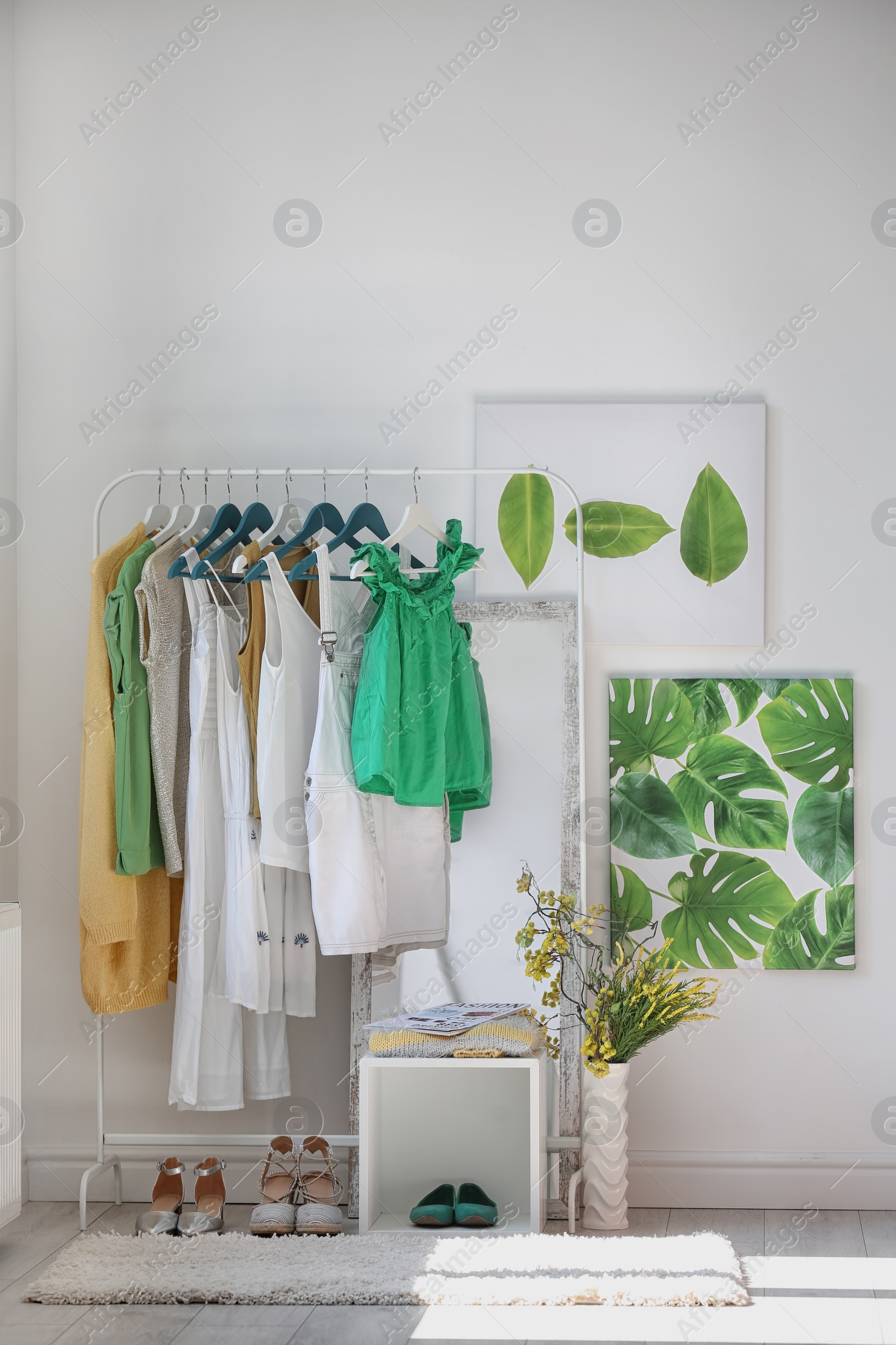 Photo of Stylish dressing room interior with clothes rack and mirror