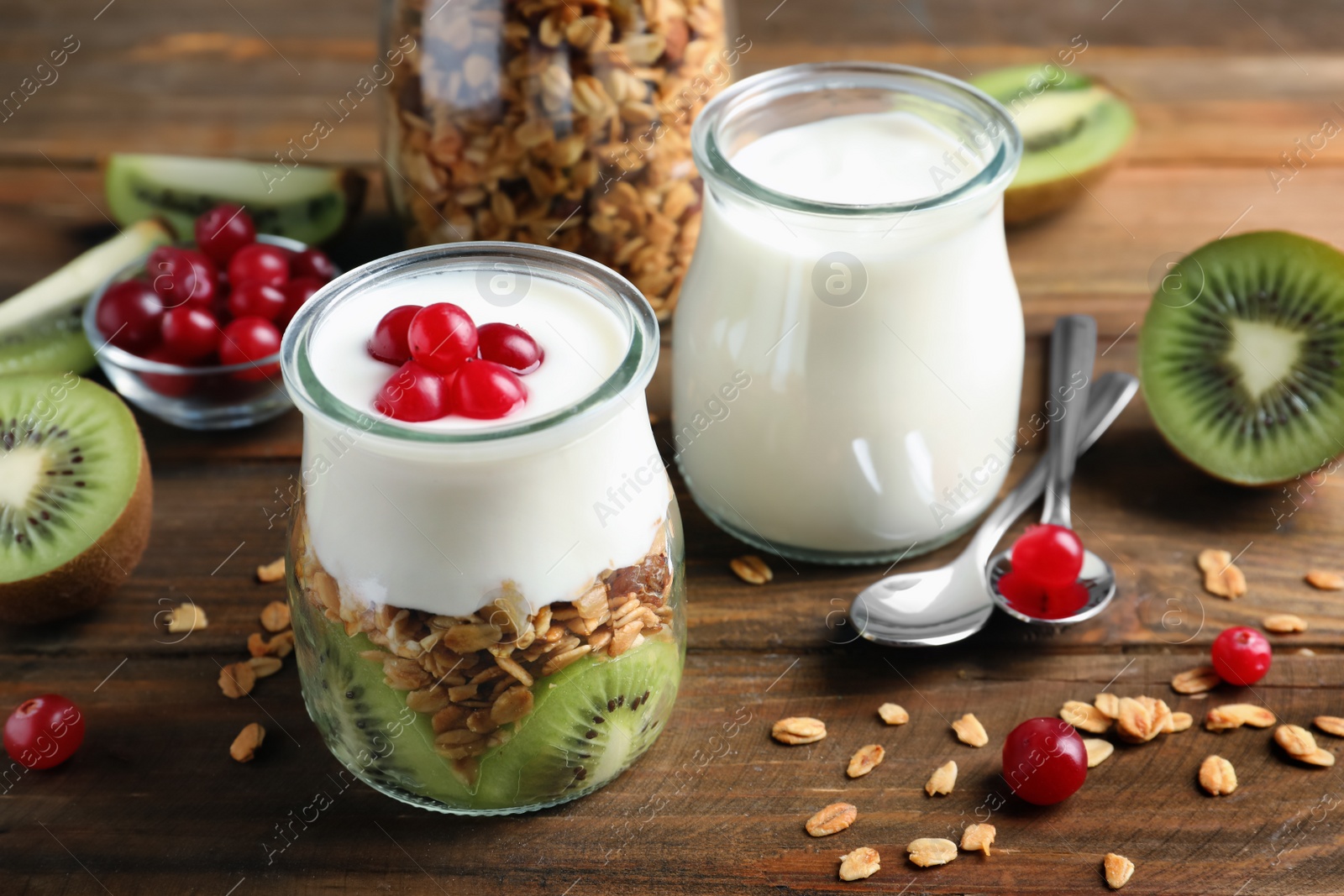 Photo of Tasty breakfast with yogurt and granola on wooden table