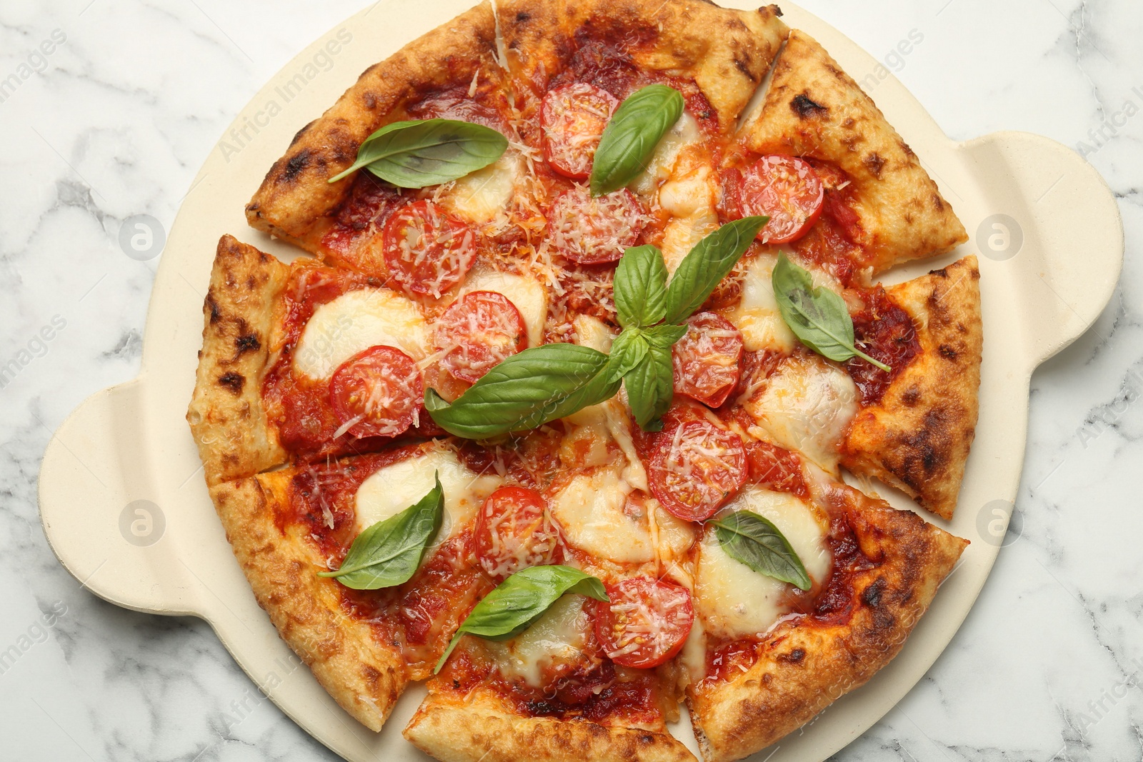 Photo of Delicious Margherita pizza on white marble table, top view