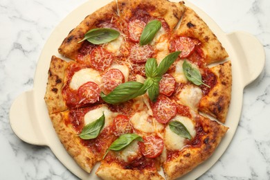 Delicious Margherita pizza on white marble table, top view