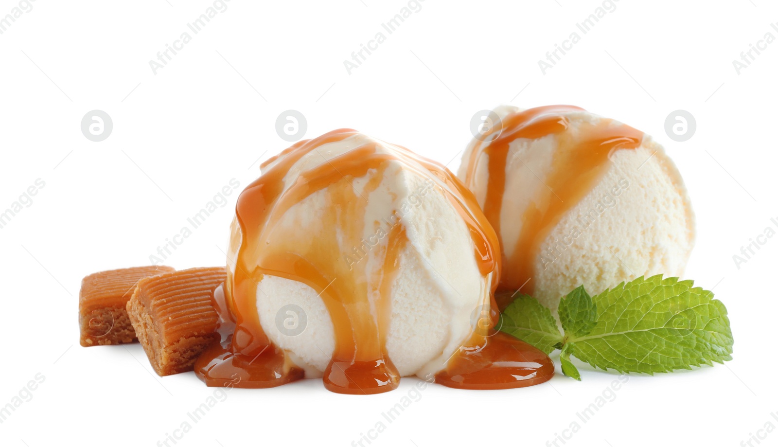 Photo of Delicious ice cream with caramel sauce, candies and mint on white background