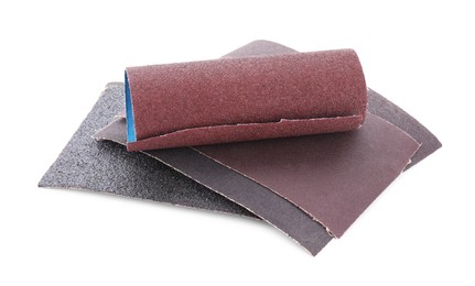 Photo of Many sheets of sandpaper isolated on white