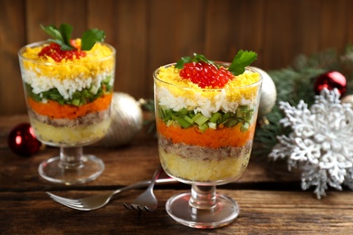 Photo of Traditional russian salad Mimosa served on wooden table