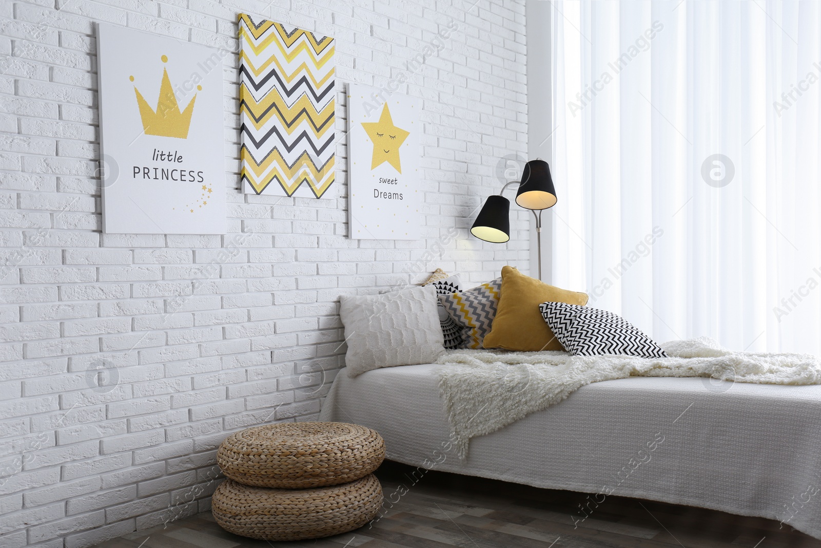 Photo of Child's room interior with bed and cute posters on wall