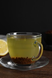 Buckwheat tea in cup on wooden table, closeup