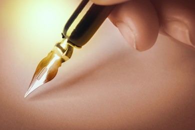 Image of Woman writing with fountain pen, closeup view