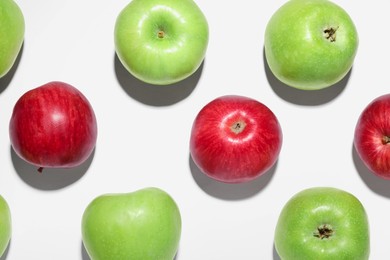 Photo of Ripe green and red apples on white background, flat lay